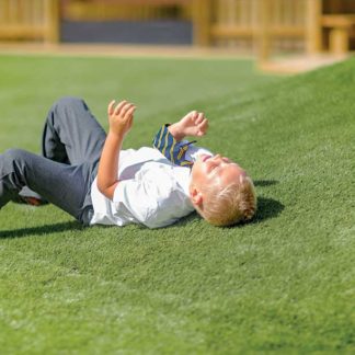 an image of a child laying on the artificial grass