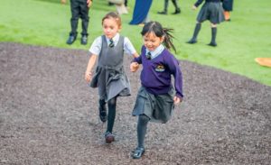 an image of children playing on the Rubber Mulch